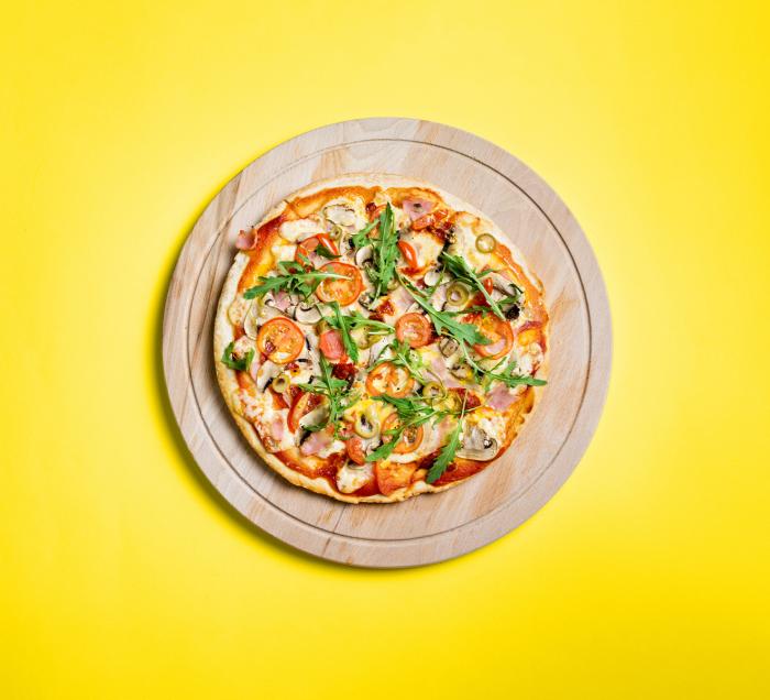 Pizza on yellow counter